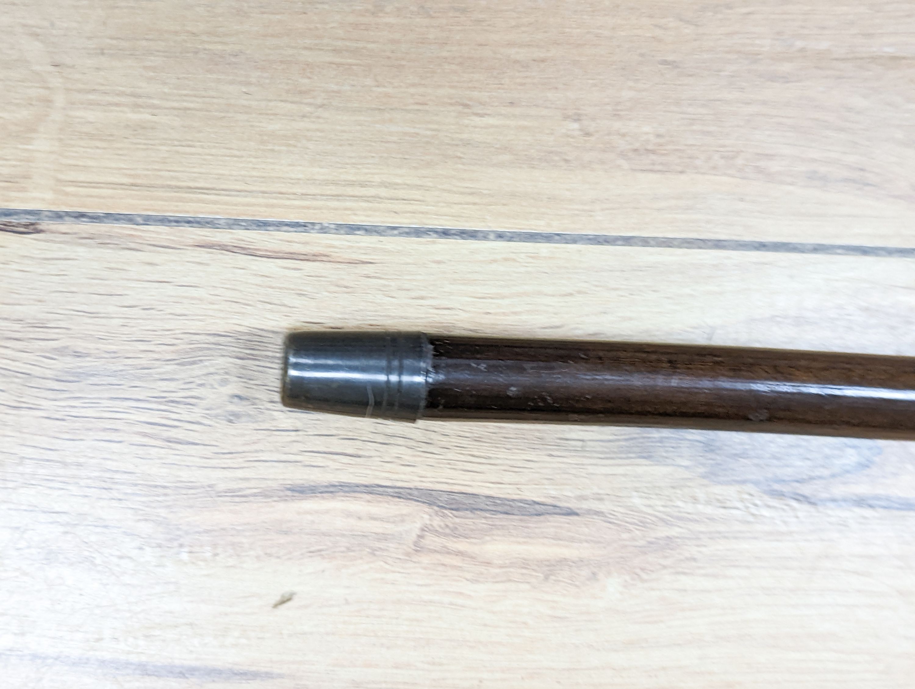 A porcelain mounted sword stick with gilt decoration to blade